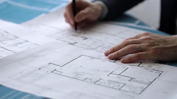 Architect makes notes on construction drawings