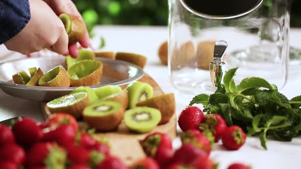 Step by step. Slicing fresh organic kiwi for infused water.