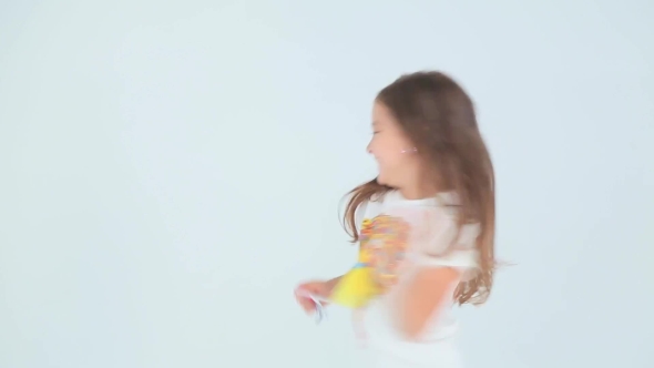 Little Girl Having Fun And Dancing On a White Background