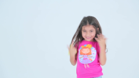 Little Girl Having Fun And Dancing On a White Background