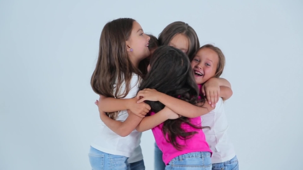Little Girls Hugging And Laughing On The White Background