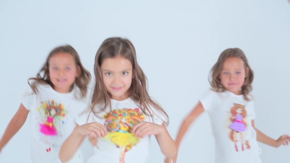 Little Girls Having Fun And Dancing On a White Background