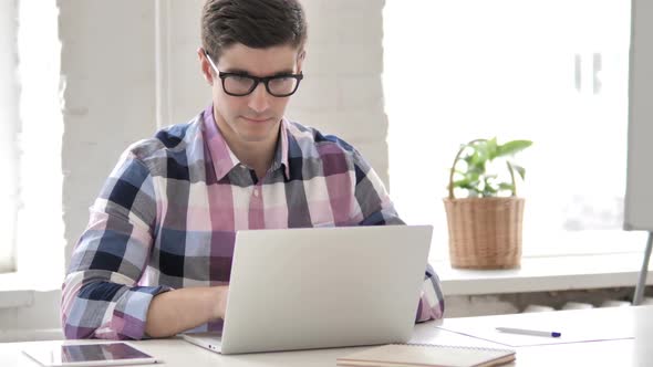 Young Man Working On Laptop