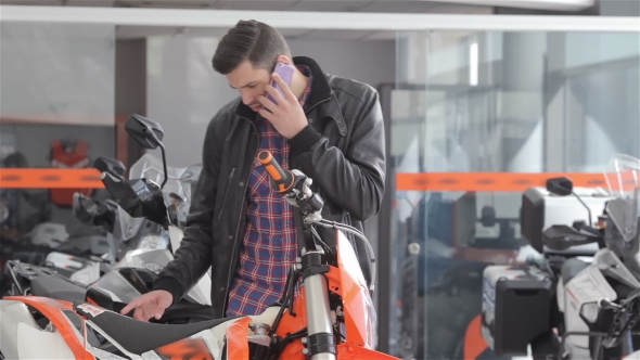 Consultant Talks On The Phone At Motorbike Salon