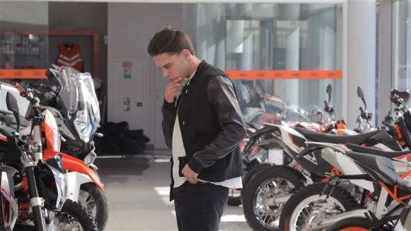 Man Choose The Motorbike At Dealership