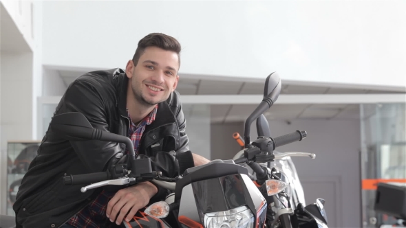 Man Poses on Motorbike