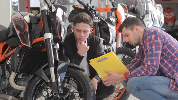 Customer Talks With Consultant About The Motorbike