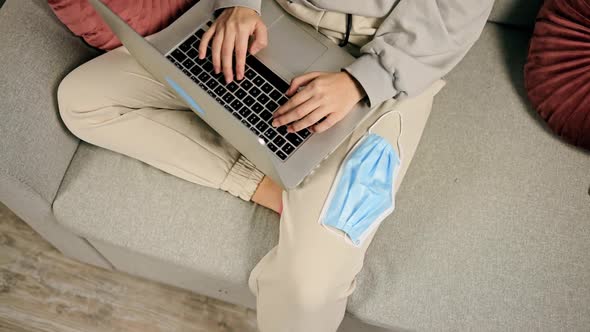 Top Down View Young Woman Using Laptop for Freelance Work at Home During Quarantine with Medical