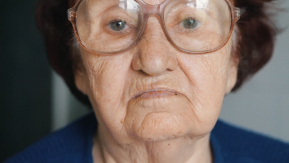  Portrait Of An Old Woman Putting On Glasses