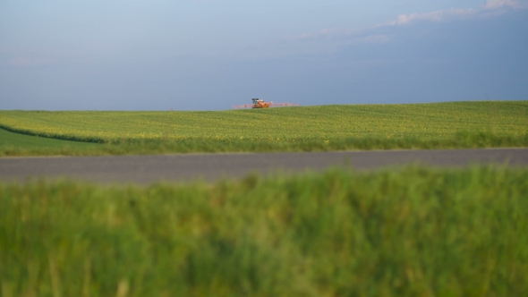 Tractor Spray Fertilize on Field With Chemicals in Agriculture Field