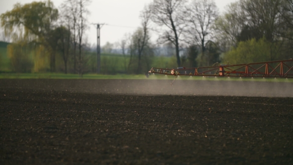 Tractor Spray Fertilize On Field With Chemicals In Agriculture Field.