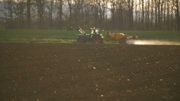 Tractor Spray Fertilize On Field With Chemicals In Agriculture Field.