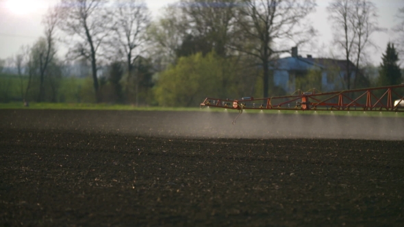 Tractor Spray Fertilize on Field With Chemicals in Agriculture Field