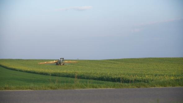 Tractor Spray Fertilize On Field With Chemicals In Agriculture Field.