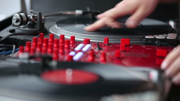 Hands Of a Disc Jockey On The Professional Mixing Controller