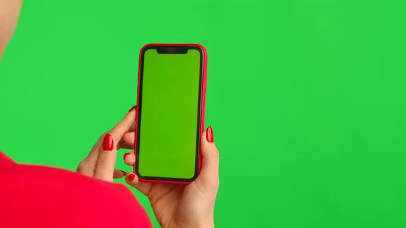 Woman Holds Mobile Phone with Workspace Mock Up Screen on Green Background