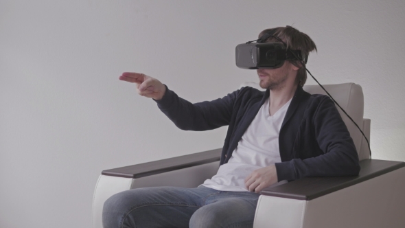 Man Wearing Virtual Reality Glasses Watching Movies Or Playing Video Games