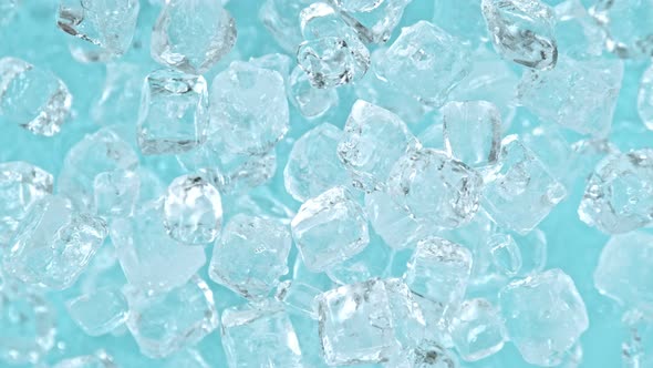 Super Slow Motion Shot of Ice Cubes Explosion Towards Camera on Light Blue Background at 1000 Fps alt