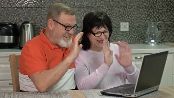 Cheerful Married Couple Are Communicating with Someone Via the Internet