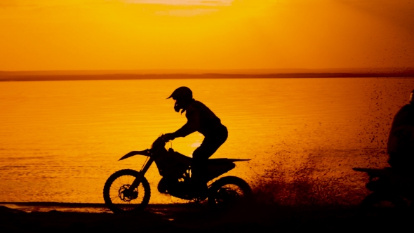 Motorcyclist At Sunset Near The River