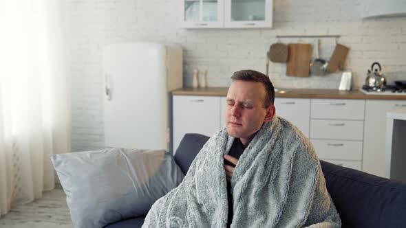 Sick young man suffering from flu at home