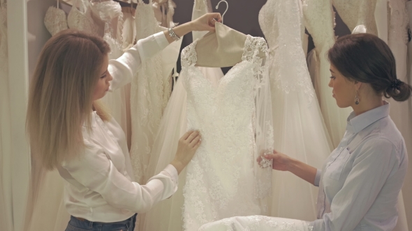 Smiling Pretty Group Of Brides Chooses White Dress At Shop Of Wedding Fashion