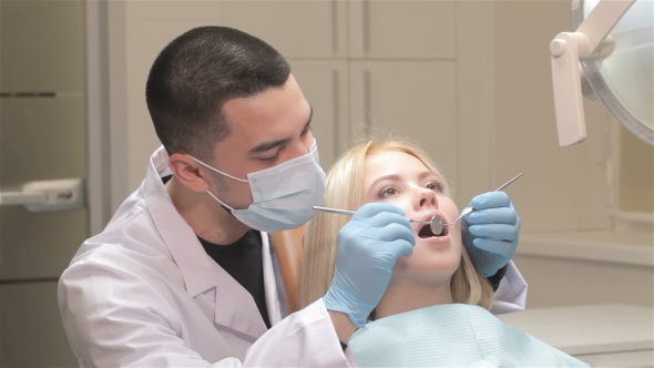 Dentist Examines Patient's Teeth
