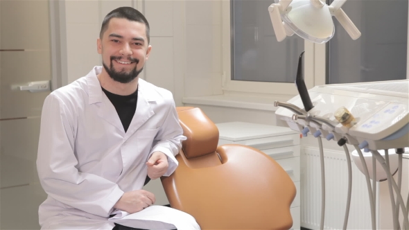 Doctor Sits Near Dentist Chair