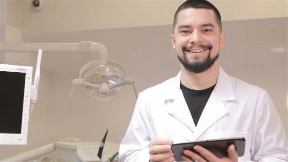 Dentist Holds Digital Tablet