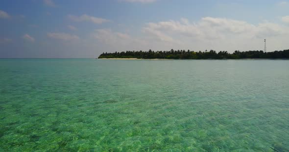 Daytime flying island view of a white sand paradise beach and blue sea background in best quality 4K