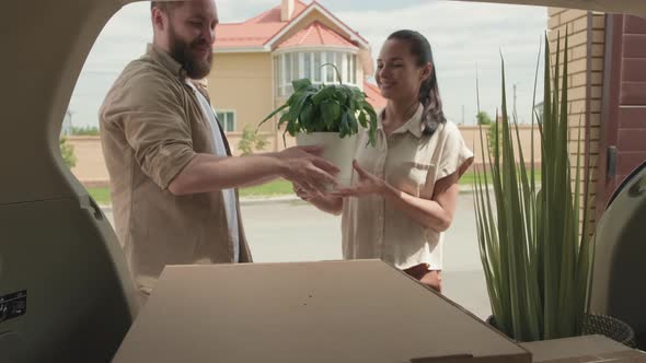 Happy Couple Unpacking Belongings and Moving House