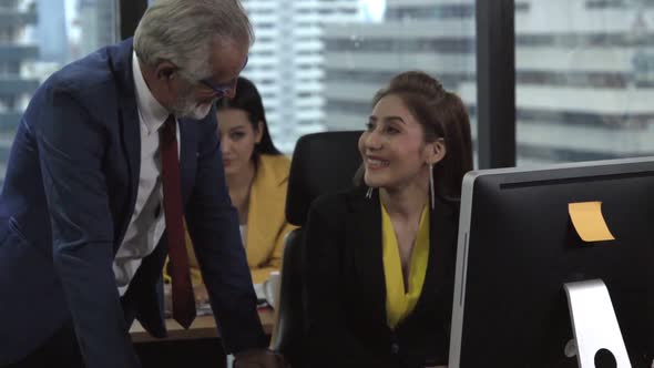 Senior Manager Gives Advice to Young Woman Worker