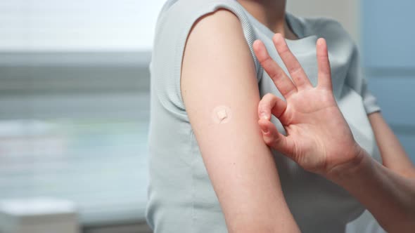 Young woman patient shows OK gesture