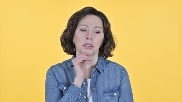 Worried Old Woman Thinking on Yellow Background