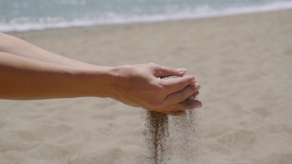 Stream Of Sand Pouring From Hands