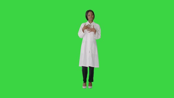 Young African American Female Doctor Talking About Medical Care on a Green Screen, Chroma Key.