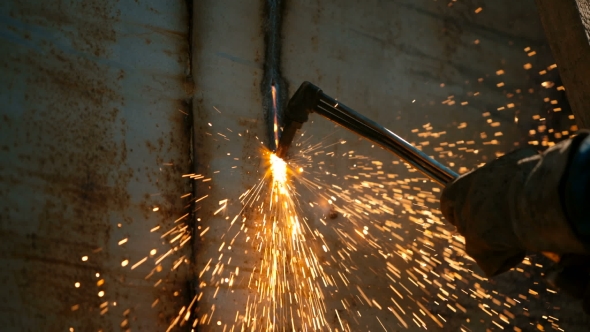 Worker Cutting Metal With Acetylene Torch