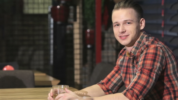 Blonde Man Drinks Alcohol At The Bar