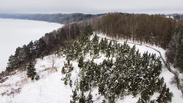 Majestic snow covered valley with wooden pathway in Lithuania