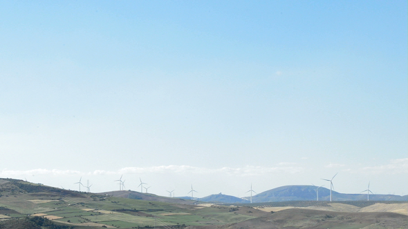 Wind Turbines Moving at Horizon at Sunny Day