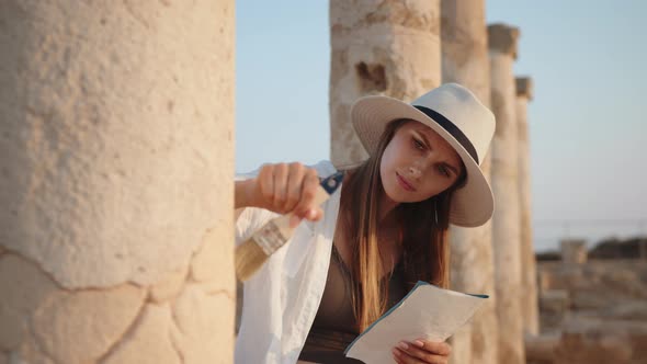 Archeologist Standing Among Ruins of Ancient Temple