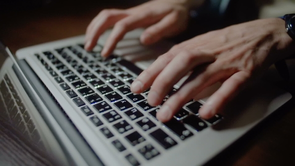 Man Typing On a Laptop Keyboard