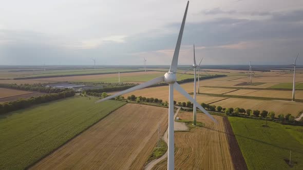 Aerial View of Wind Turbine Generators in Field Producing Clean Ecological Electricity