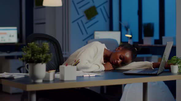 Exhausted Overload African Business Woman Falling Asleep on Desk