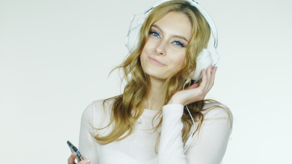Attractive Woman Listening To Romantic Music On Headphones