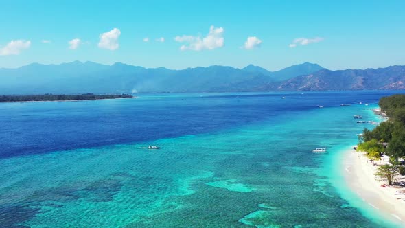 Aerial drone shot texture of marine shore beach trip by clear ocean with white sand background of jo