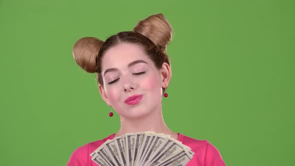 Teen Sniffs Paper Bills and She Is Delighted. Green Screen. Close Up. Slow Motion