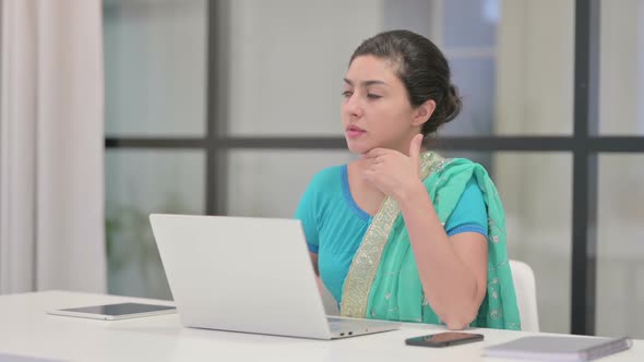 Indian Woman Thinking While Working on Laptop in Office