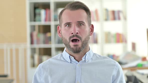 Portrait of Worried Young Man Feeling Shocked