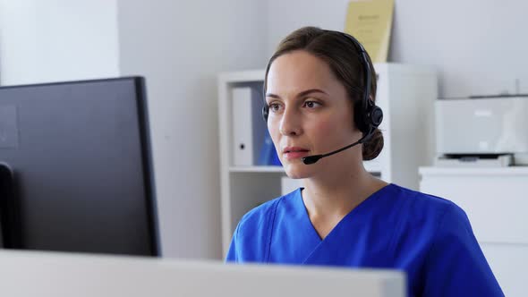 Doctor with Headset and Computer at Hospital